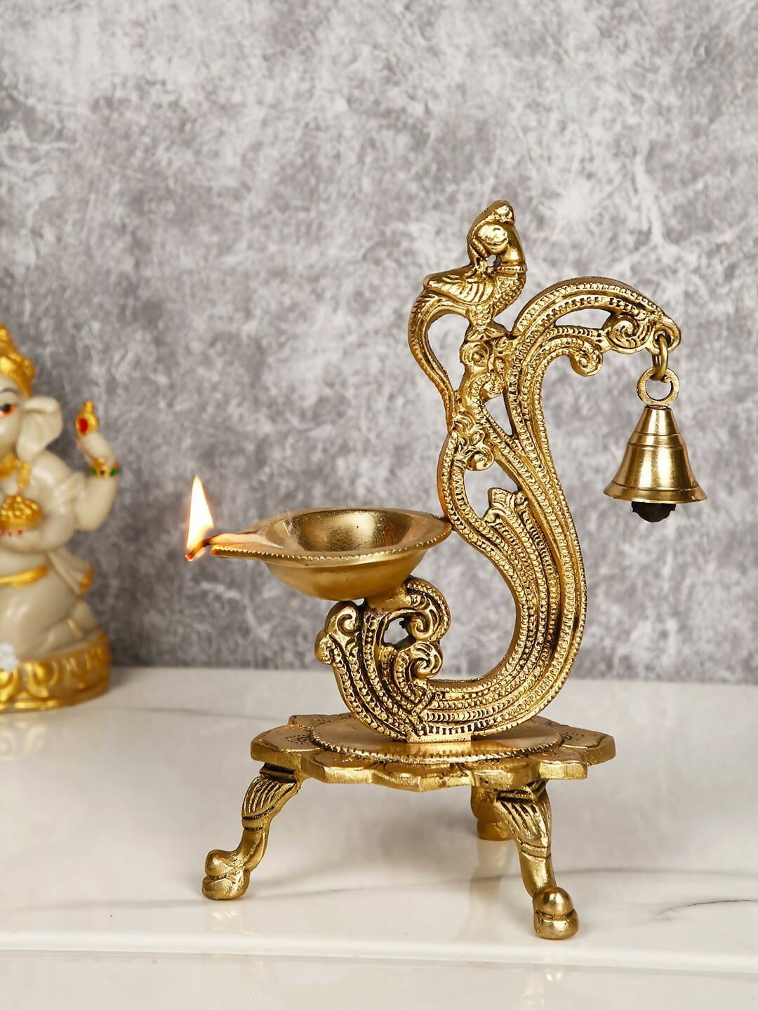 CraftVatika Gold-Toned Brass Handmade Decorative Peacock Design Diya with Bell & Stand